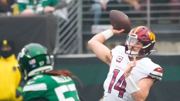 Dec 24, 2023; East Rutherford, New Jersey, USA; Washington Commanders quarterback Sam Howell (14) throws against the New York Jets in the first quarter at MetLife Stadium.